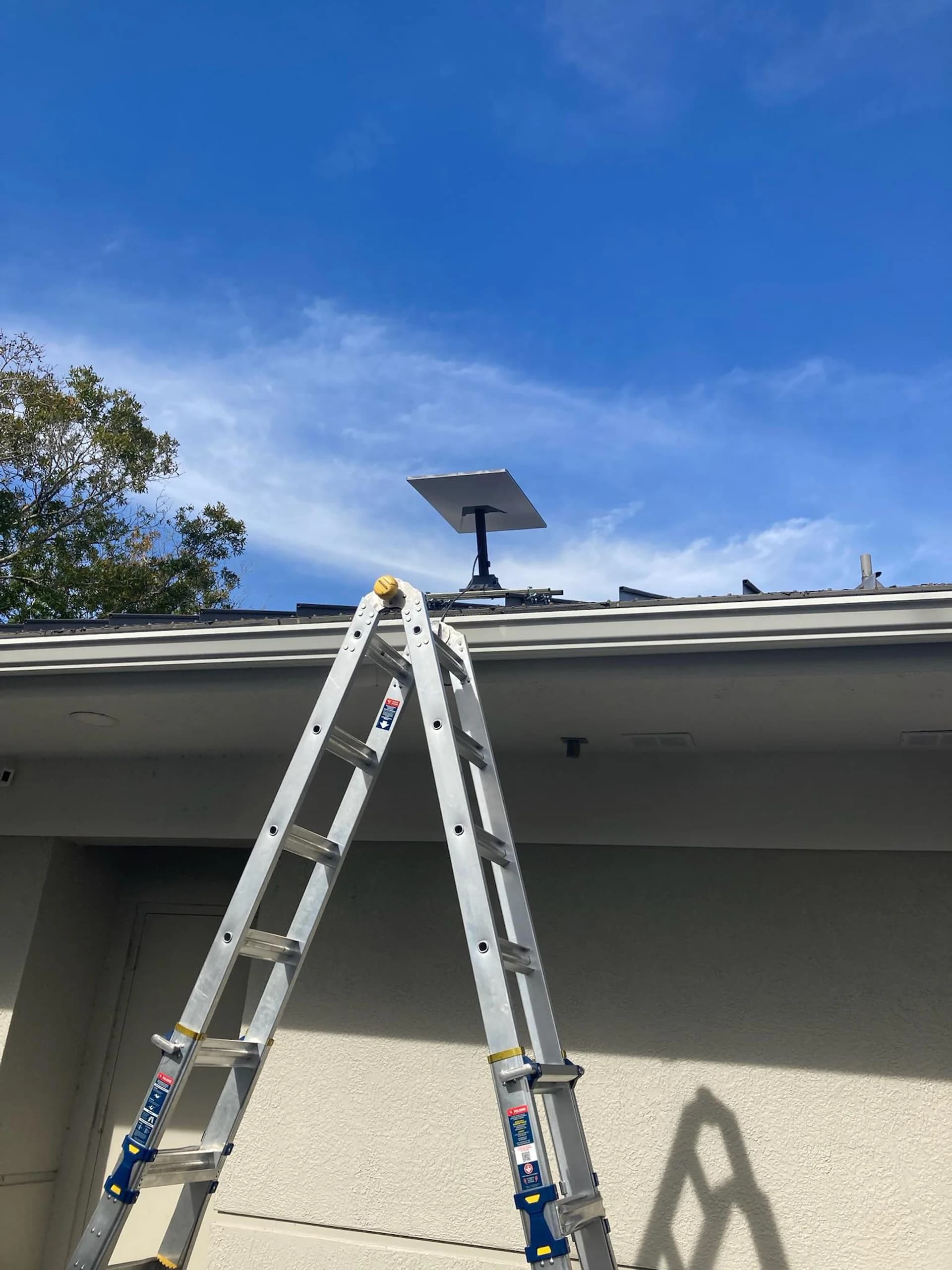 Living room TV mounted above fireplace with hidden wires